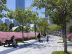 People walking and sitting on benches in Jinan Ribbon Park. 