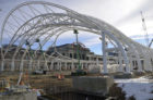 The primary structural system for the train hall consists of 11 steel arch-trusses that support a tensioned PTFE fabric. These trusses span nearly 180 feet from a single large-diameter pin connection atop 18-foot-tall arched column supports. Each truss is stabilized by bracing struts. At the center of the train hall, the arch-trusses are replaced by cantilevered trusses, opening the canopy to the sky. In profile, the canopy rises 70 feet at either end and descends in a dynamic sweep to 22 feet at the center—a gesture that protects the passenger platforms below while providing views of the historic station.