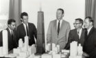 Faz Kahn, Bruce Graham, William Brown, and others look at a model of the John Hancock Center